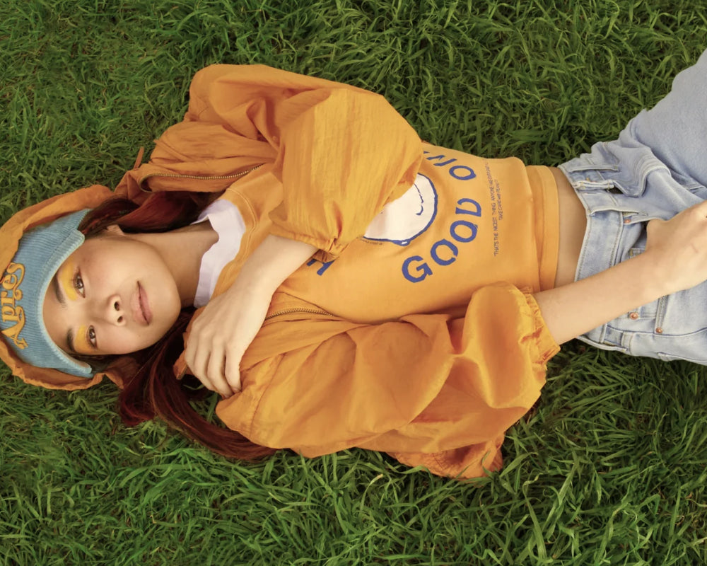 Woman laying comfortably on lush green grass